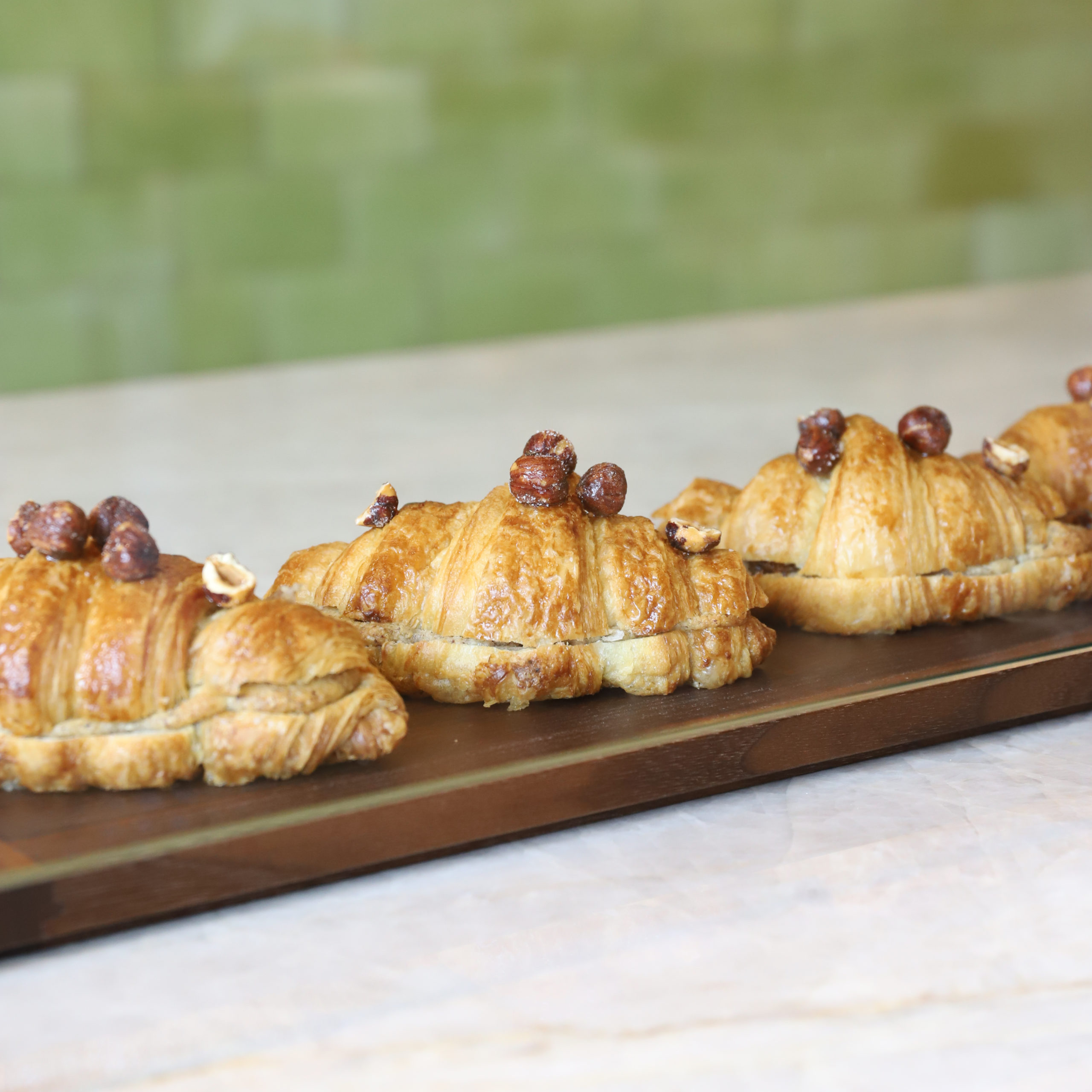 image of croissants lined on a board