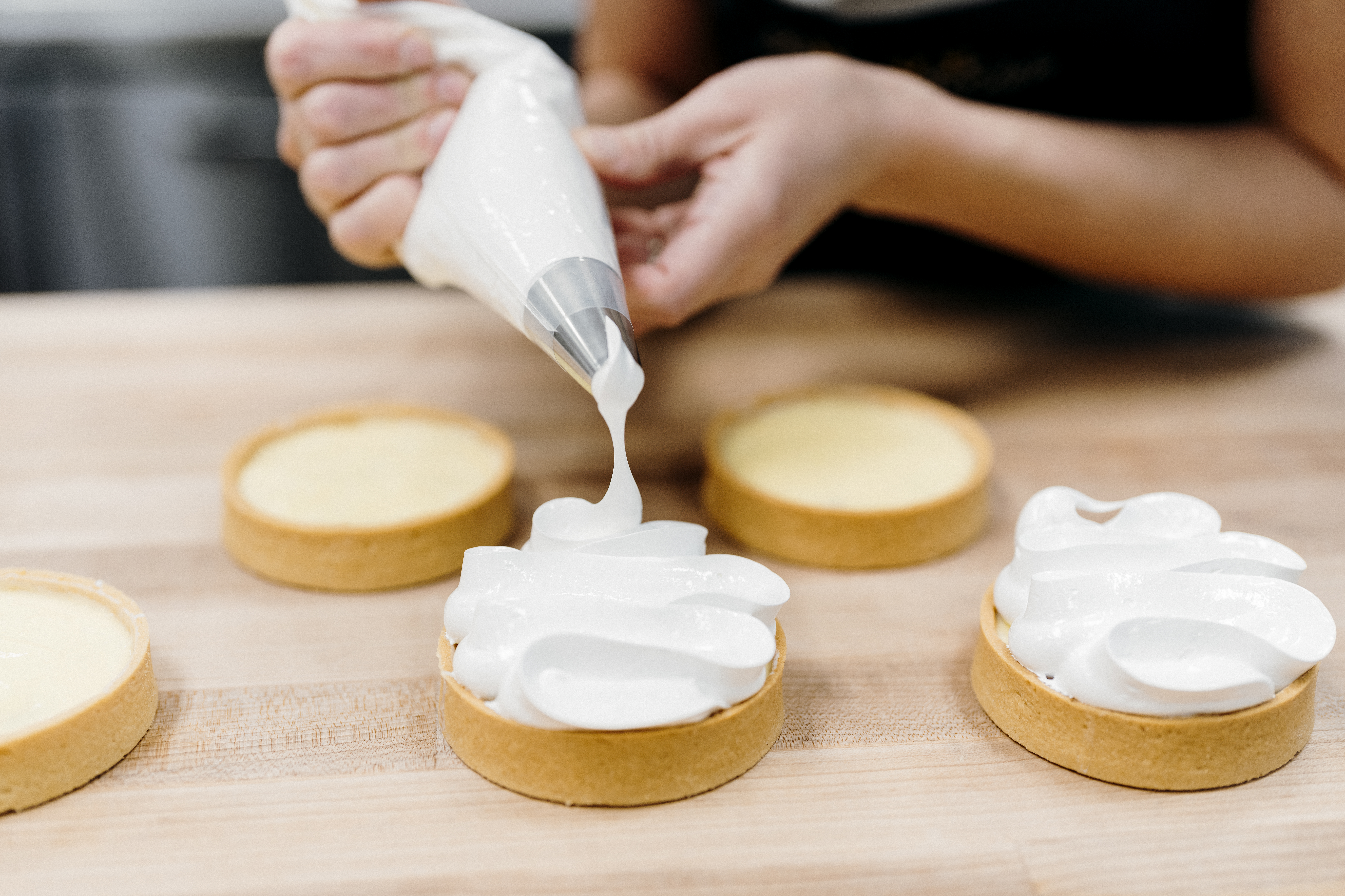 image of chef adding topping to key lime tart