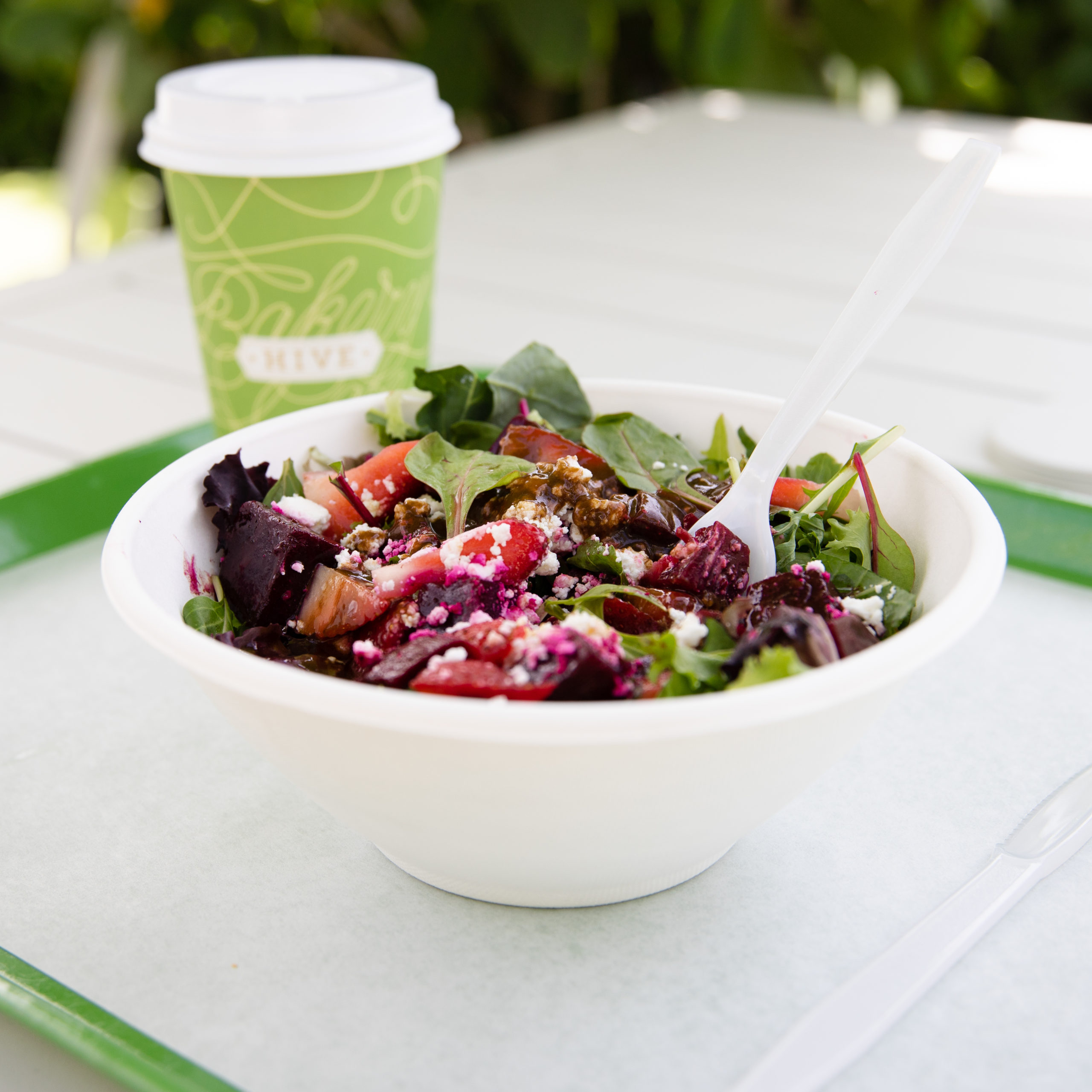 Photo of salad and Hive coffee cup
